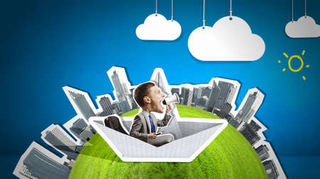 Businessman escapes from the crisis on a paper boatの写真素材