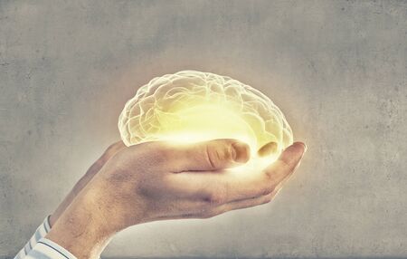 Close up of human hand holding brain
