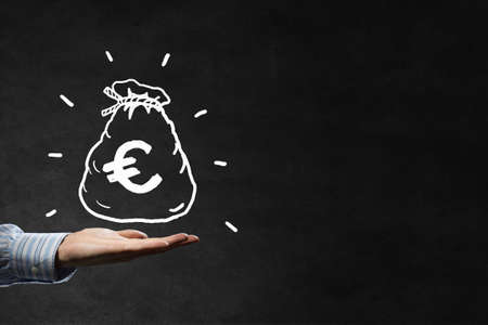 Businessman hand holding drawn money bag in palmの写真素材