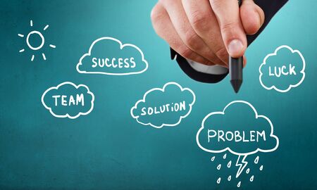 Businessman hand drawing business idea concepts on blue backgroundの写真素材