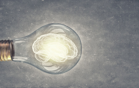 Idea concept with brain inside of light bulbの写真素材