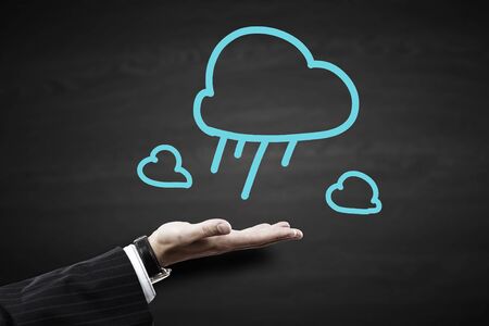 Human hand and drawn cloud in palmの写真素材