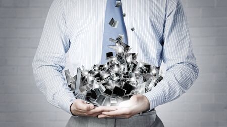 Close up of businessman's hands holding many laptopsの写真素材