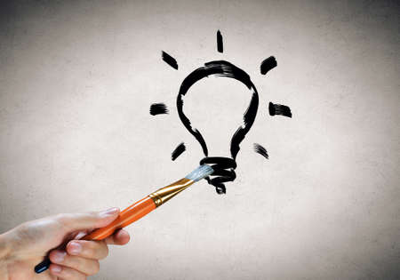 Close up of hand drawing light bulb with markerの写真素材