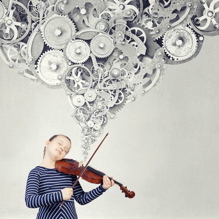 Cute kid girl playing violin and gears flying outの写真素材