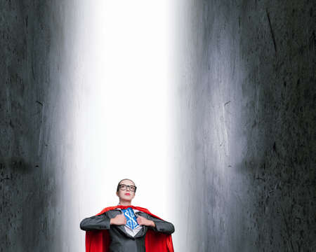 Young woman acting like super hero with dollar sign on chestの写真素材