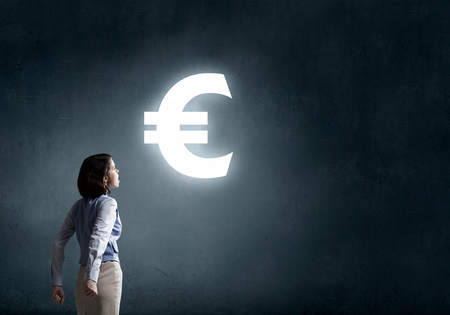 Young businesswoman making fists and screaming up in despairの写真素材