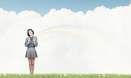 Young beautiful woman taking photo with retro cameraの写真素材