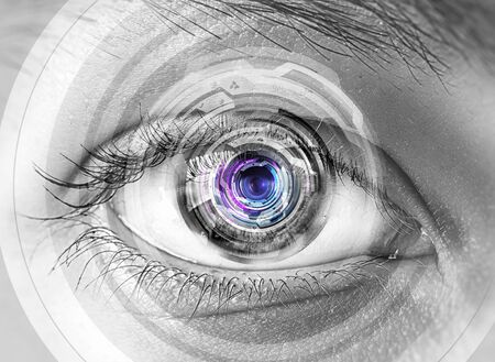 Close up of human eye on digital technology backgroundの写真素材