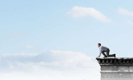 Young determined businessman in starting position ready to compete