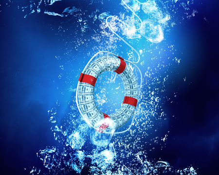 Life insurance concept with life buoy sink in clear blue waterの写真素材