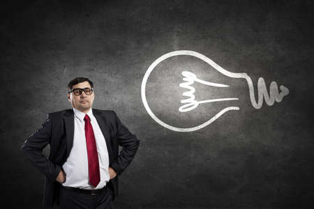 Middle aged confident businessman hands on waist