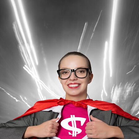 Young woman acting like super hero with dollar sign on chestの写真素材