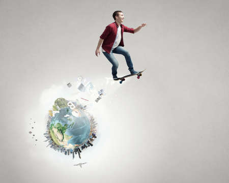 Handsome teenager cool acive boy riding skateboard. Elements of this image are furnished by NASA