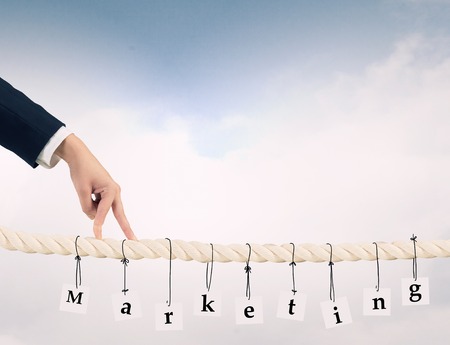 Close up of businessman hands walking with fingers on rope as partnership conceptの写真素材