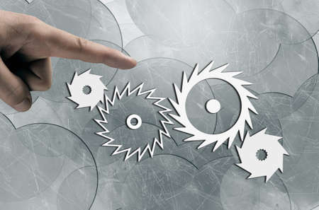 Close up human hand pointing with finger at gears mechanismの写真素材