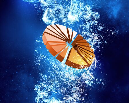 Business financial graph sink in clear blue waterの写真素材