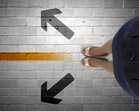 Top view of businesswoman feet standing at crossroadsの写真素材