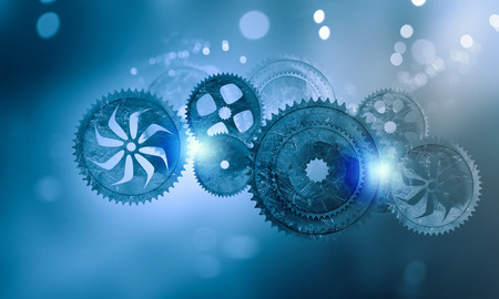 Mechanism of metal gears and cogwheels on blue background