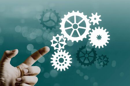 Close up human hand pointing with finger at gears mechanism