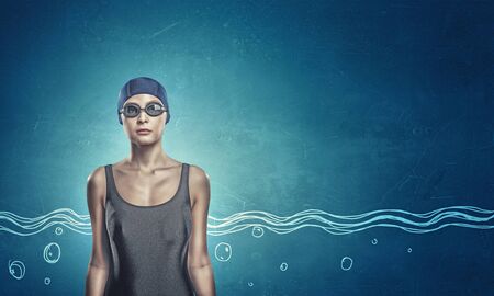 Portrait of woman swimmer in cap and glassesの写真素材