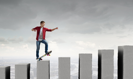 Handsome teenager cool acive boy riding skateboardの写真素材