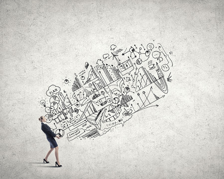 Young businesswoman carrying her great business plan in handsの写真素材