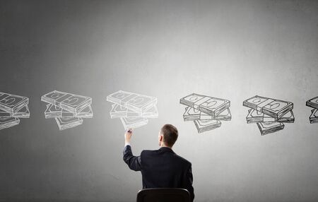 Rear view of businessman drawing with marker money earning conceptの写真素材