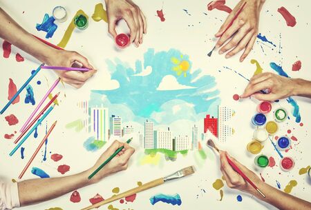 Top view of people hands drawing urban concept with paintsの写真素材