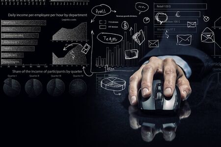 Hand of businessman in suit on dark background using wireless computer mouse