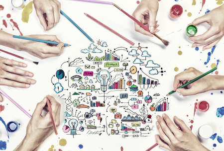 Top view of people hand drawing business creative concept with paintsの写真素材