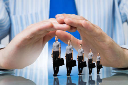 Miniature of businesswoman with suitcase protected with careの写真素材