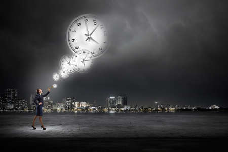 Young pretty businesswoman playing melody on trumpetの写真素材