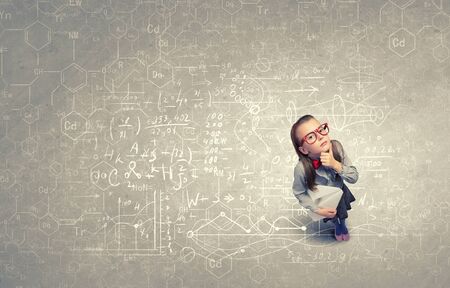 Wideangle picture of funny schoolgirl with paper plane in handの写真素材