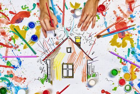 Top view of hands drawing house colorful conceptの写真素材
