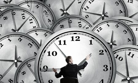 Rear view of businessman sitting in chair slowing timeの写真素材