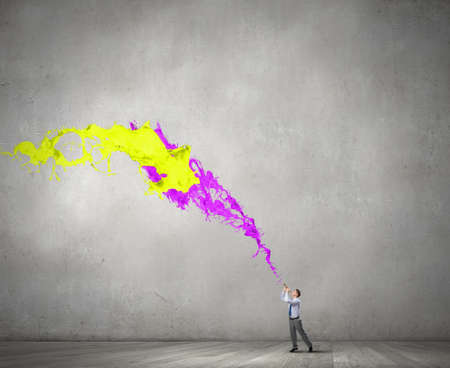 Young businessman playing pipe and colorful splashes coming out