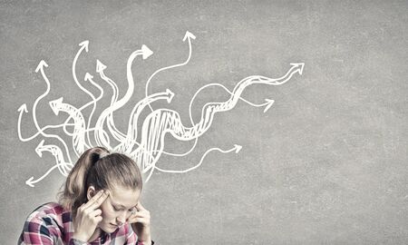Pretty young woman making decision with arrows above her head