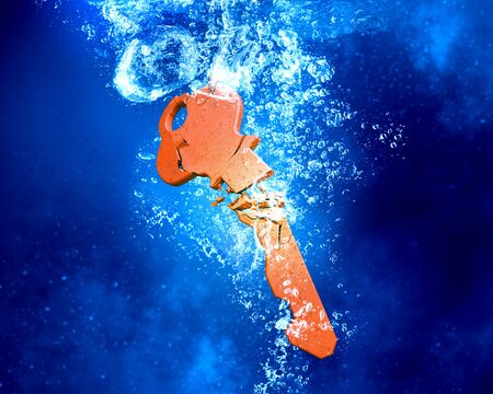 Key sinking and dissolving in clear blue waterの写真素材