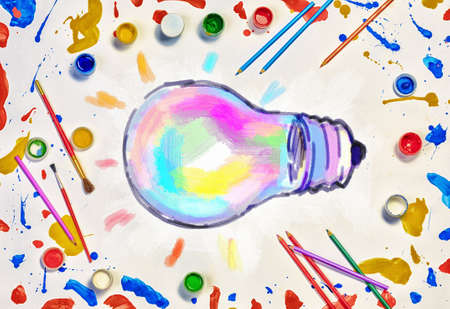 Colorful paint and brushes on white paper as symbol of creative ideaの写真素材