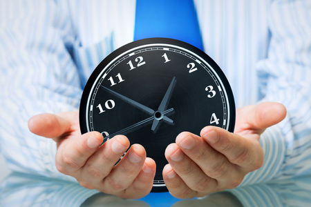 Hands of businessman holding with care time concept