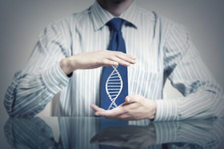 Hands of businessman holding with care molecule conceptの写真素材