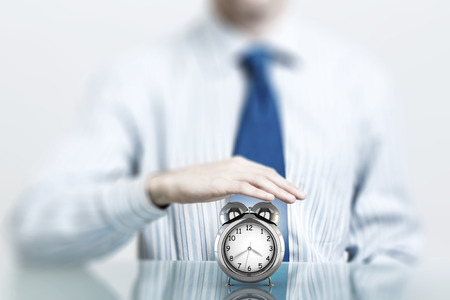 Hands of businessman holding with care time conceptの写真素材