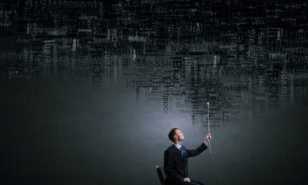 Businessman in chair and leadership conceptual words in airの写真素材