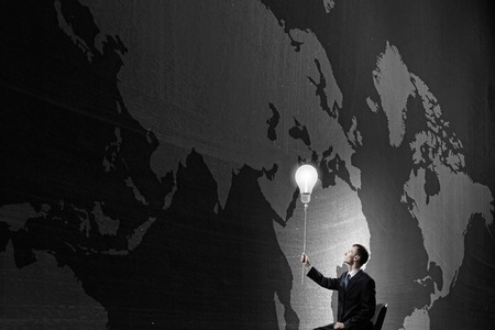 Businessman with bulb on rope representing bright ideaの写真素材