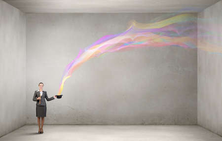 Attractive businesswoman with flute and bowler hat in handの写真素材