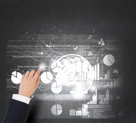 Businessman analyzing financial statistics displayed on tablet screenの写真素材