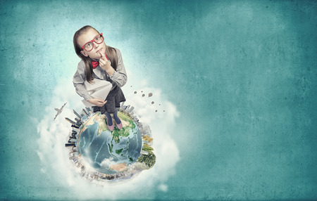 Wideangle picture of funny schoolgirl with paper plane. Elements of this image are furnished by NASAの写真素材