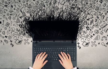 Top view of businesswoman hands using black laptopの写真素材