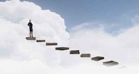 Young confident businesswoman with hands on waistの写真素材